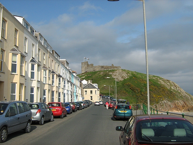 criccieth castle ontop of the hill, seen from a road lined with guesthouses